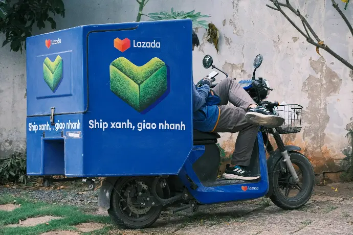 a man riding on the back of a blue moped